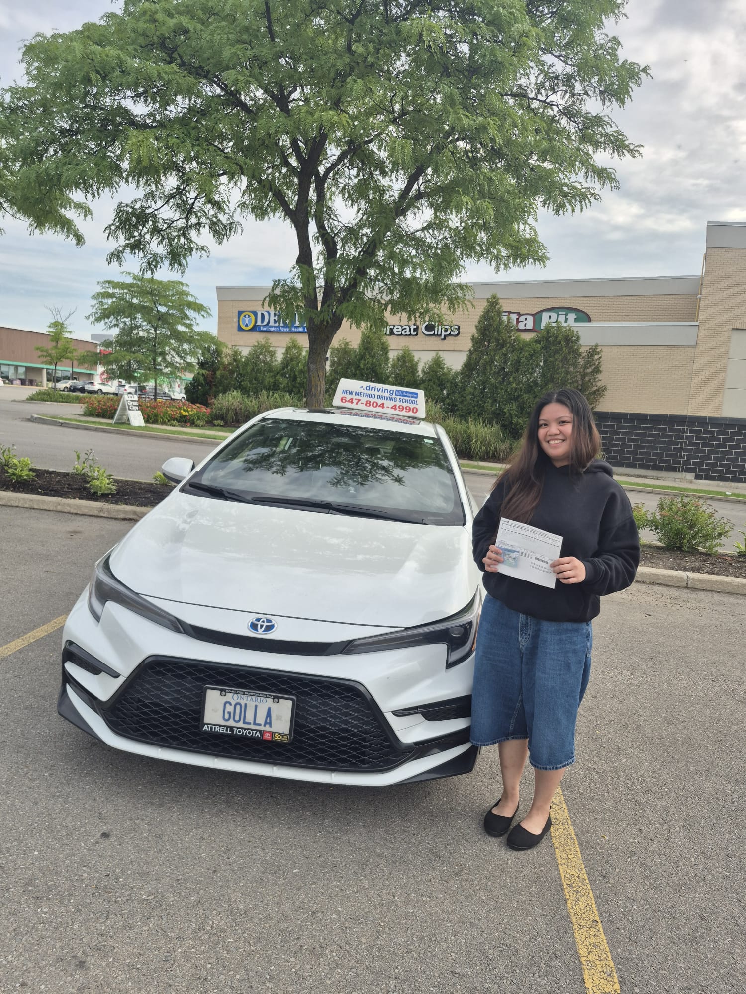 Student proudly passing road test with Golla Driving School 2025 Toyota Corolla Sport